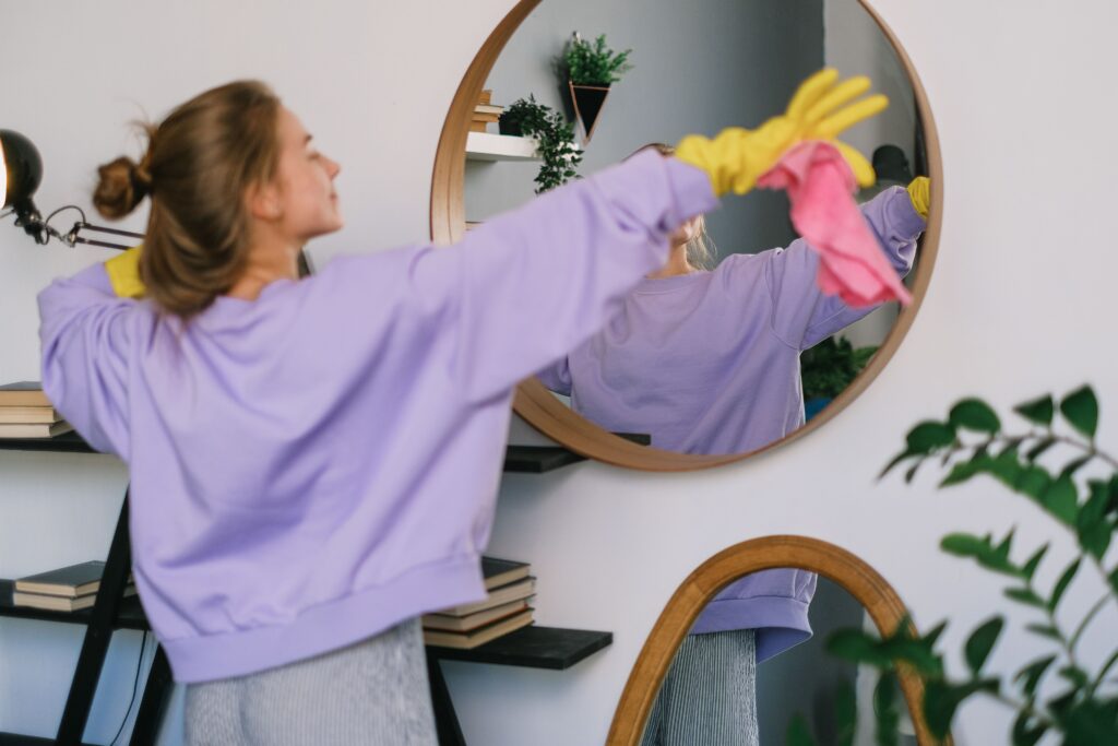 pexels photo 7513035 7513035 Back view of young female in casual clothes and yellow latex gloves dancing while cleaning light living room in daytime